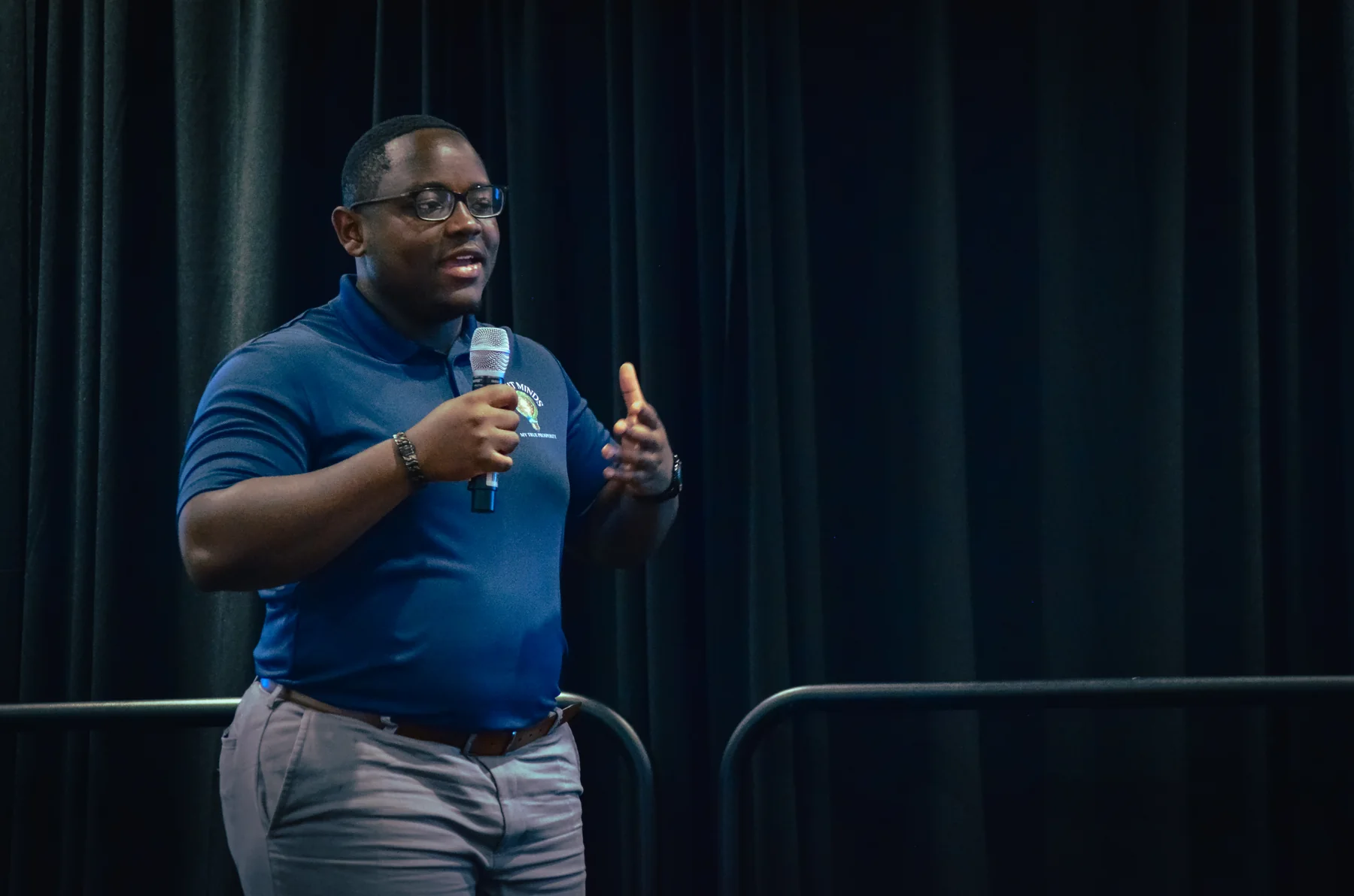 Bright Minds alumnus speaking while wearing a Bright Minds polo
