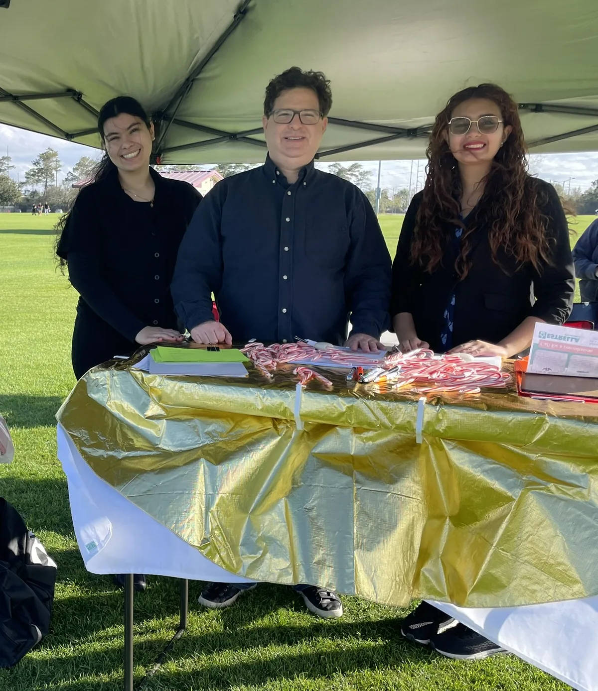 Bright Minds team members welcoming the community at an outdoor event table